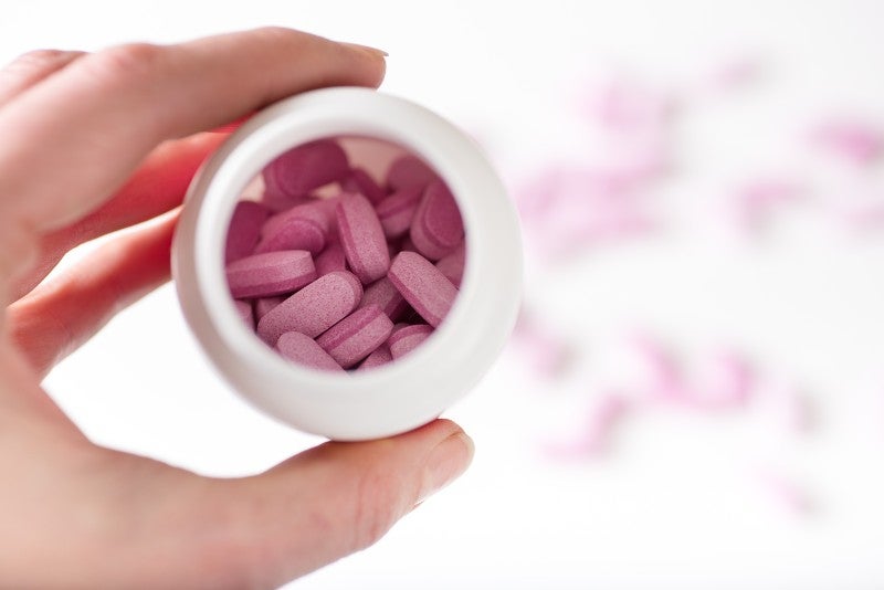pink bilayer tablets in tub